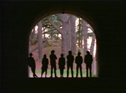 Seven silhouettes in a stone archway